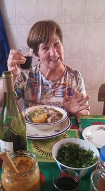 My Chilean host mom that I stayed with while I taught English in South America. She's toasting with a glass of wine and smiling.