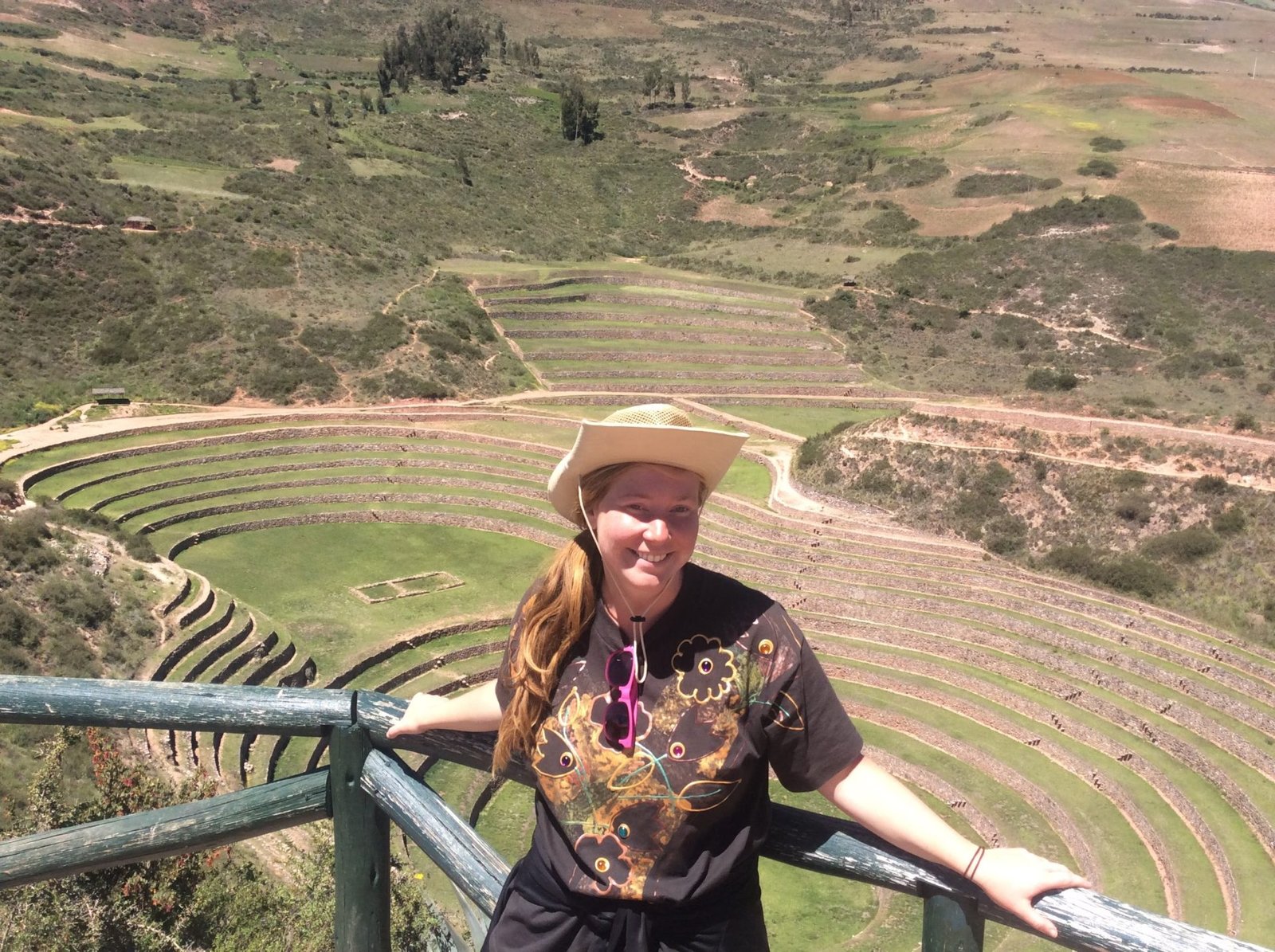 looking at the incan ruins in maras with a funky hat