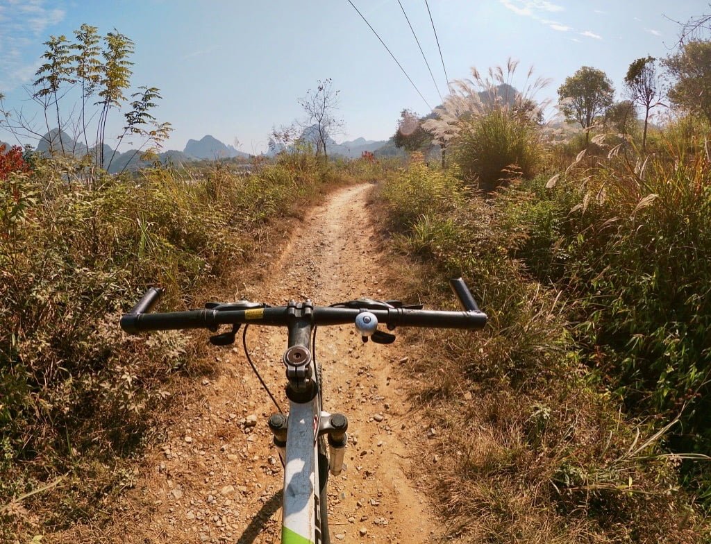 Bike riding in the Yangshuo countryside along a dirt road