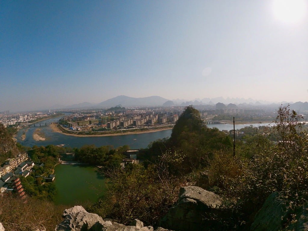 A view of the city of Guilin, a river, and some karst hills, taken while hiking Diecai Hill in Guilin.