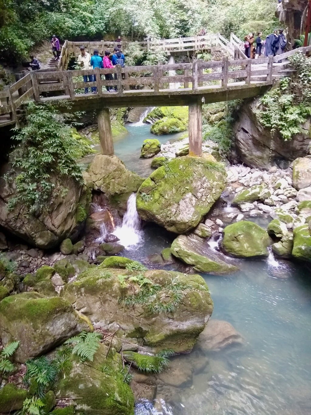 A pathway at Longshuixia Gorge, with small cascades and running water underneath the pathway.  Longshui Gorge is a top attraction in Wulong, Chongqing. 