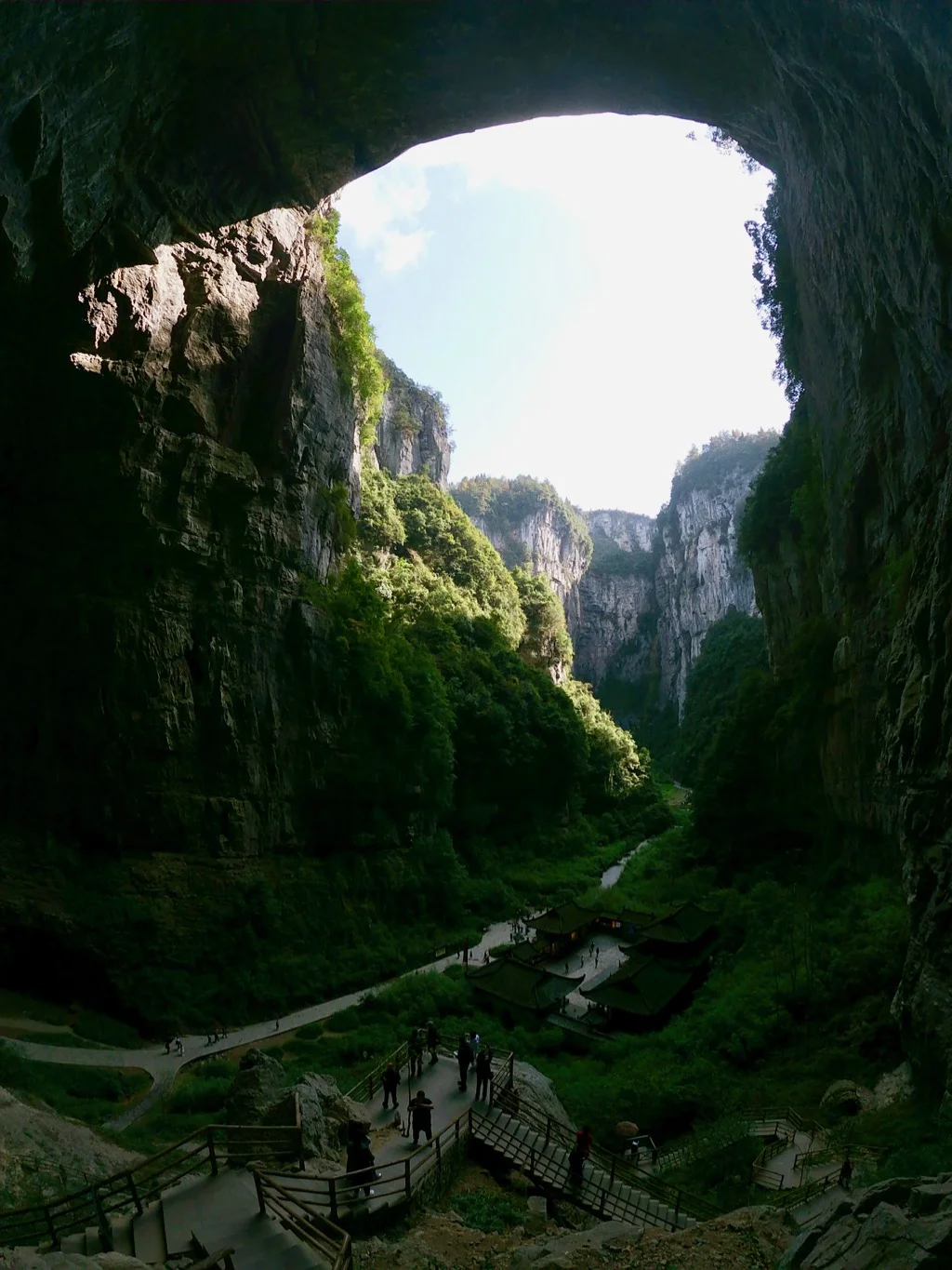Three Natural Bridges, Wulong A famous viewpoint of the 3 Natural Bridges in Wulong, looking down on a traditional Chinese-built building. The Three Bridges are located in the Wulong Karst National Geology Park.