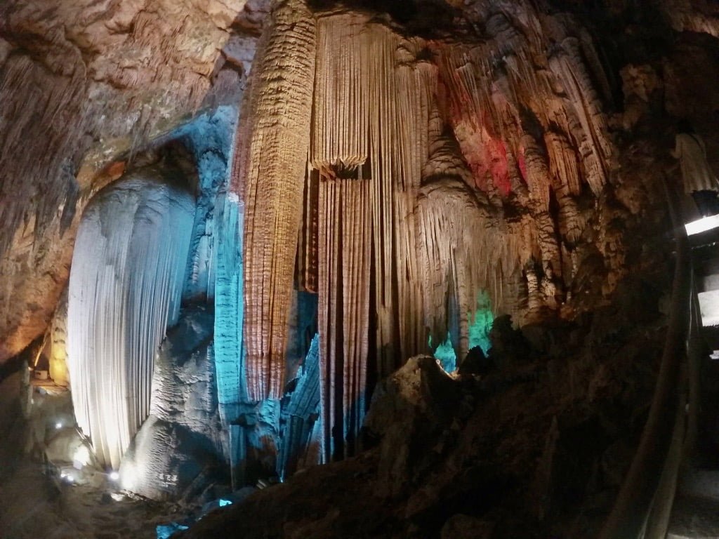 Furong Cave, one of the best things to do in Wulong. The cave is lit up with many different-colored lights.