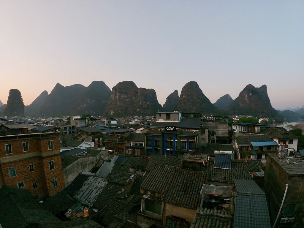 A rooftop view of the old part of Yangshuo town (West Street) with karst mountains in the background