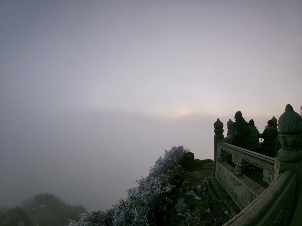 An obscured, cloudy sunrise at the top of Emeishan, after completing the whole trek
