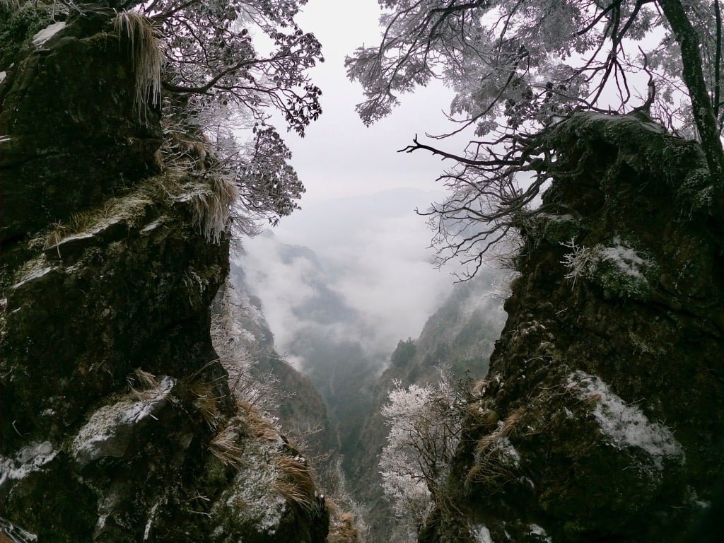 A fish-eye look through two somewhat snowy mountain sides into the distance on Emei Shan, a sacred mountain near Chengdu