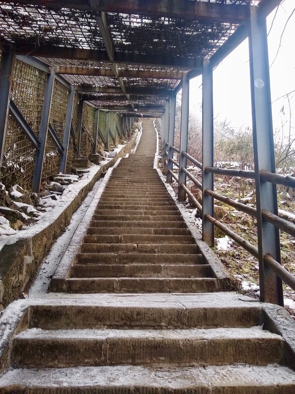 Very steep stairs on the Emei Shan hike with a dusting of snow