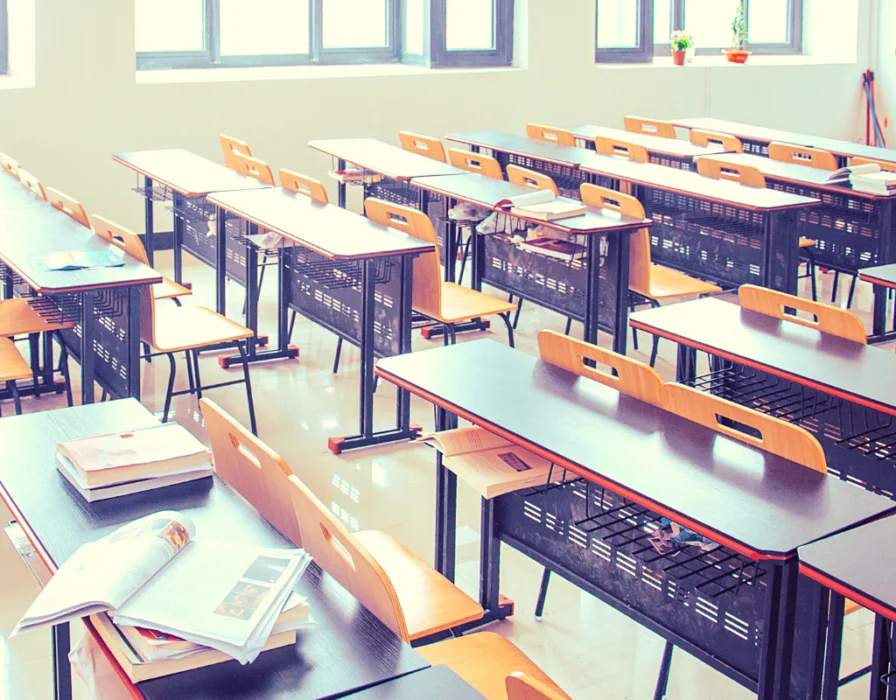 My review of teaching English at EF English First. Picture of an empty classroom and papers on desks.