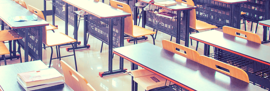 My review of teaching English at EF English First. Picture of an empty classroom and papers on desks.