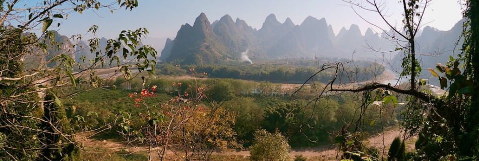 A farm and lots of karst hills in the background, located in Xingping near Guilin, China
