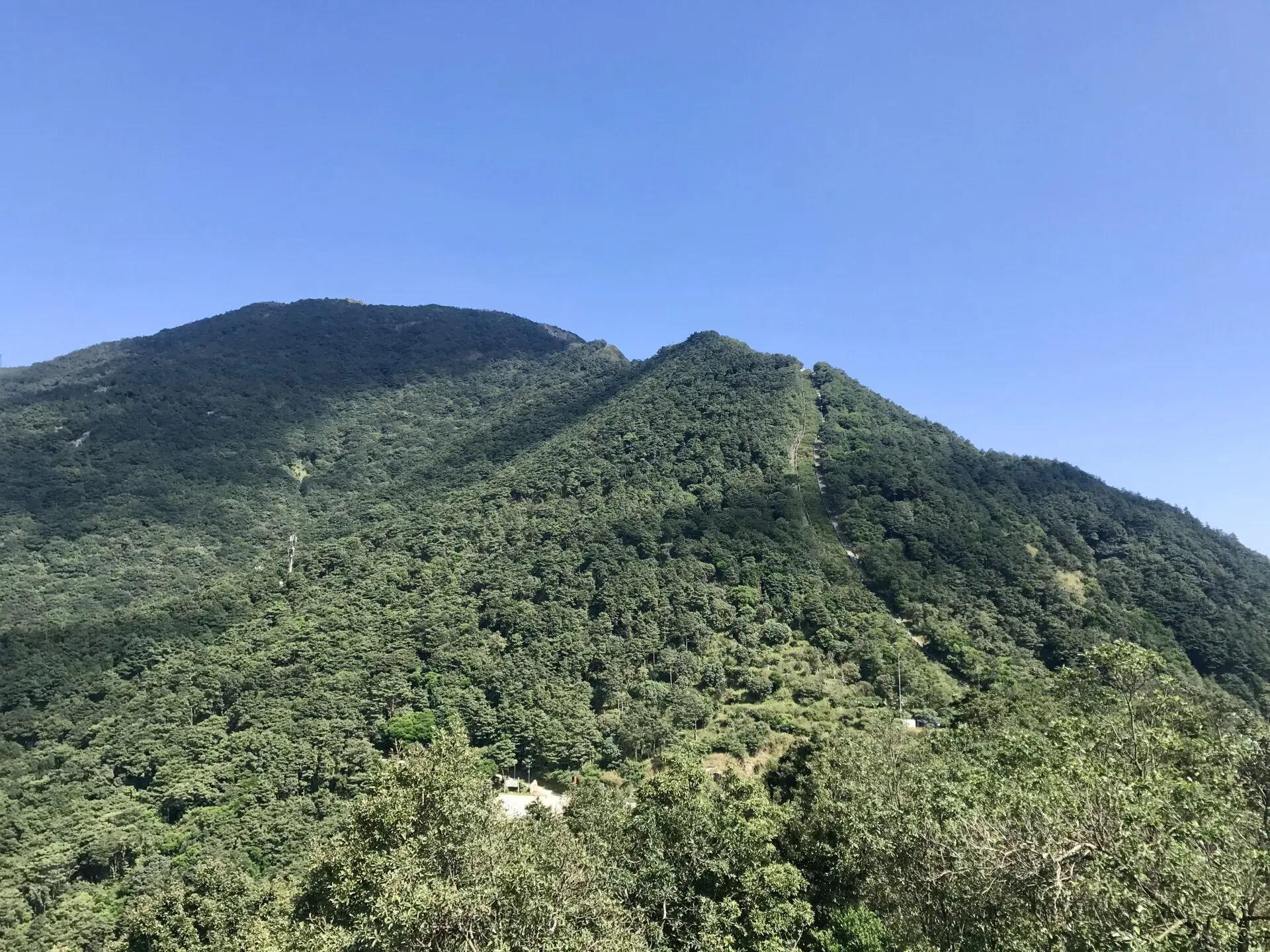 Stairs leading up a big hill, located at Wutong mountain in Shenzhen with lots of greenery